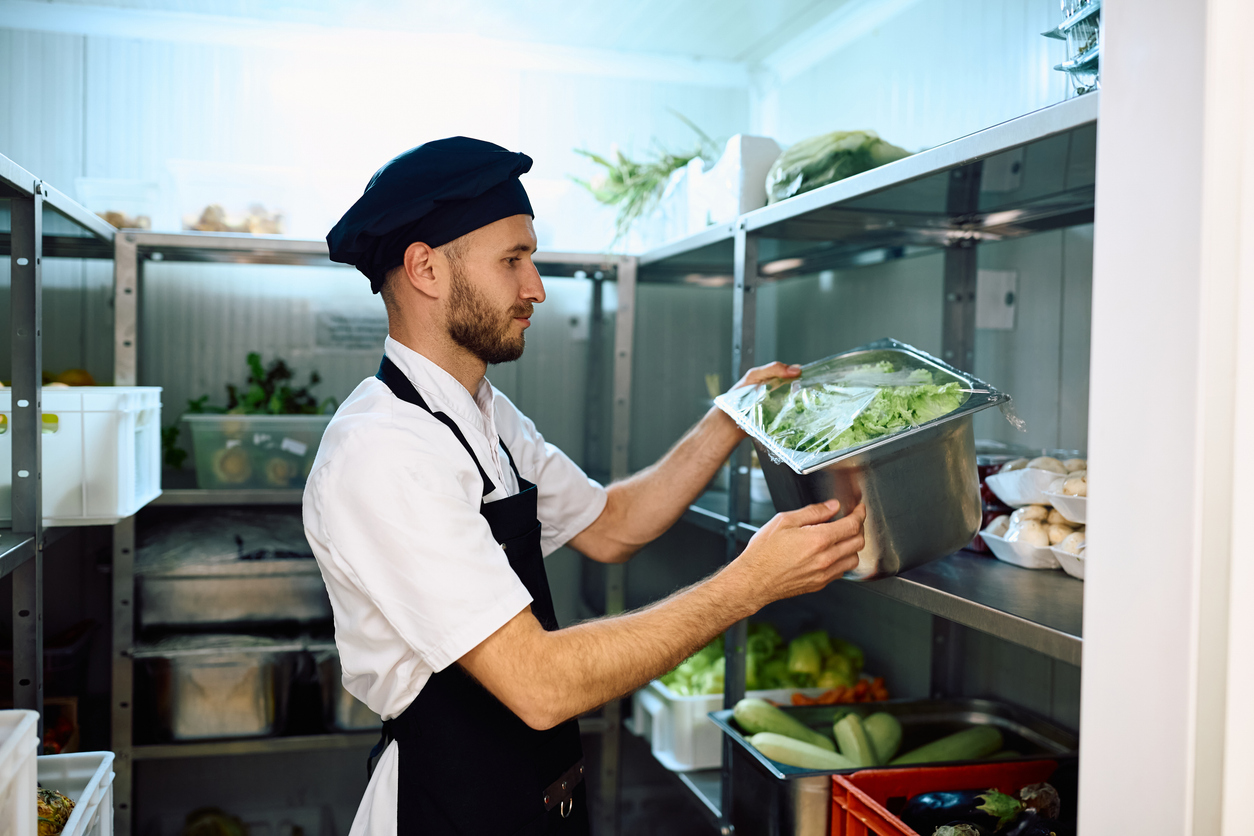 Chef taking fresh groceries from the pantry room.